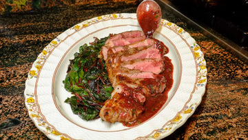 Cabernet Porcini Chef Butter Sauce on New York Steak with Roasted Shallot Chef Butter Swiss Chard