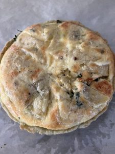 Cooked, whole ArtiHeart and Kale Tart with Roasted Shallot Chef Butter Crust
